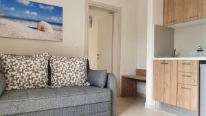 a living room with a couch and a kitchen at Astra Sarti Luxury Suites in Sarti