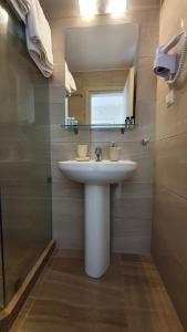 a bathroom with a sink and a mirror at Astra Sarti Luxury Suites in Sarti