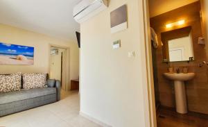 a bathroom with a couch and a sink in a room at Astra Sarti Luxury Suites in Sarti