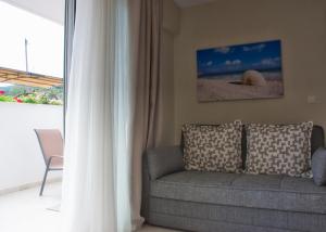a living room with a couch and a window at Astra Sarti Luxury Suites in Sarti