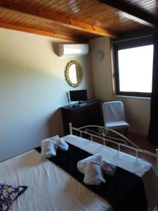 a bedroom with a bed and a desk and a mirror at Appartamento con solo camera e bagno senza cucina in Casale