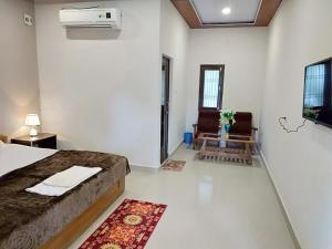 een slaapkamer met een bed, een bank en een tafel bij Hotel Jungle Palace Resort in Umariā