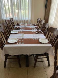 a long table with plates and wine glasses on it at Hotel Grant in Kharkiv