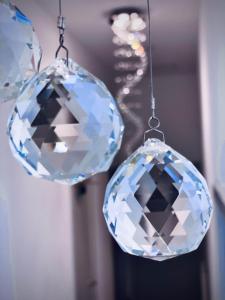 a large diamond is hanging from two chandeliers at No 49 a spacious executive apartment in Inverness in Inverness