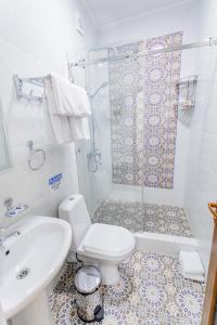 a bathroom with a toilet and a shower and a sink at Registon Saroy Hotel in Samarkand +59 photos