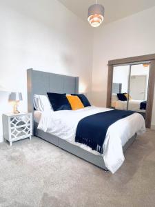 Un dormitorio con una cama grande y un espejo. en No 49 a spacious executive apartment in Inverness, en Inverness
