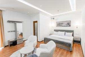 a bedroom with a bed and a table and chairs at Registon Saroy Hotel in Samarkand