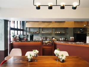 a dining room with a table and a bar at Golden House in Bangkok