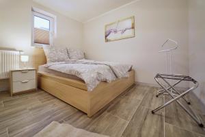 ein Schlafzimmer mit einem Bett und einer Lampe darin in der Unterkunft Bungalow am Neustädter See in Neustadt-Glewe