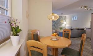 a dining room and living room with a table and chairs at Bungalow am Neustädter See in Neustadt-Glewe