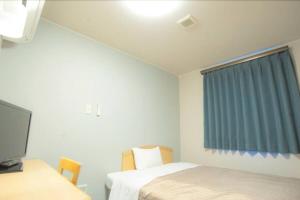 藤枝市にあるFujieda Ogawa Hotel フジエダオガワホテルのベッド2台、テレビ、窓が備わる客室です。