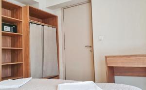 a bedroom with a bed and a closet and a door at Astra Sarti Luxury Suites in Sarti
