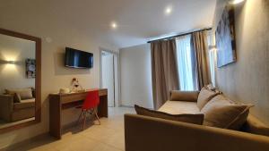 a living room with a couch and a table and a mirror at Astra Sarti Luxury Suites in Sarti