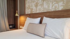 a bedroom with a bed with white pillows at Astra Sarti Luxury Suites in Sarti