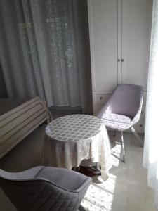 a room with a bench and a table and a chair at Cospea B&B in Terni