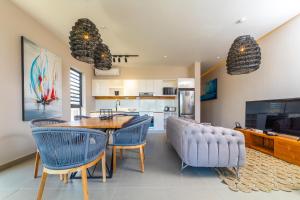a kitchen and dining room with a table and chairs at ONE BAY RESIDENCE NO 8 in Grand Baie