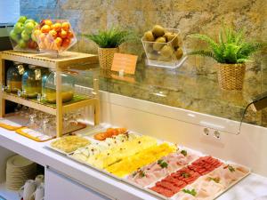 a buffet with many different types of food on display at Ibis Styles Madrid Prado in Madrid