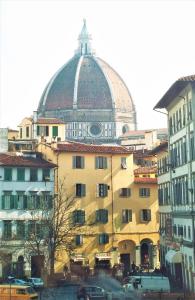 a large building with a domed roof in a city at Hotel Regina in Florence