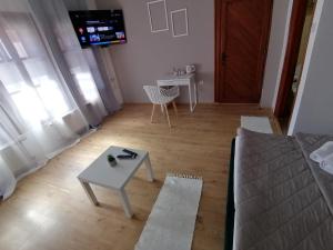 a living room with a couch and a table at MON Accommodation free parking in Niš