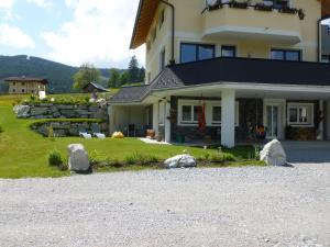 a house with rocks in front of it at Ferienwohnung Bergblick in Filzmoos