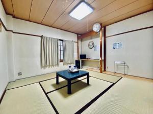 a room with a table in the middle of a room at Naeba Lodge Oka in Yuzawa