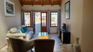 a living room with a couch and a tv at Bismarck Swakopmund in Swakopmund