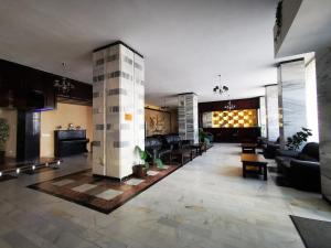 a large living room with couches and a pillar at Hotel Unirea in Focşani
