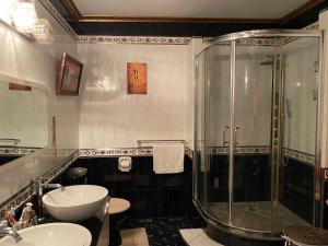 a bathroom with a glass shower and a sink at Mountain Palace in Guarata +103 photos