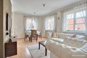 a living room with a white couch and a table at Royal Warsaw Apartment in Warsaw