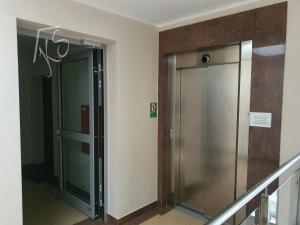 a elevator in a building with a glass door at Amko Style Apartamenty Rustica 31 Willa Nord in Jastrzębia Góra
