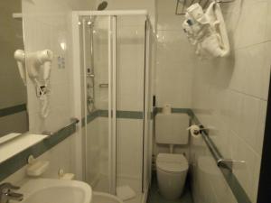 a bathroom with a shower and a toilet and a sink at Hotel Tirreno in Genoa