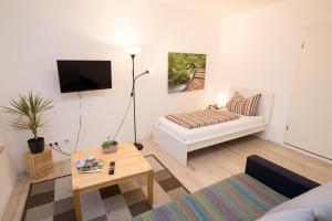 a living room with a couch and a table at FeWo Engler Lauenburg Bahnhofstraße in Lauenburg