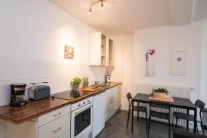 a kitchen with a table and a counter top at FeWo Engler Lauenburg Bahnhofstraße in Lauenburg