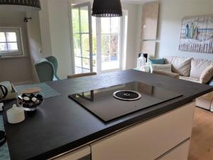 a kitchen with a black counter top in a living room at Deichblick - a26817 in Büsumer Deichhausen