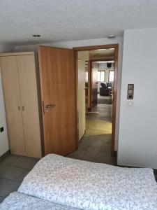 1 dormitorio con 1 cama y puerta que da a un pasillo en FeWo Iris en Alsfeld