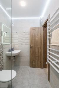 a bathroom with a sink and a toilet and a shower at Apartment Trayana in Stara Zagora