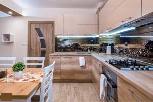a kitchen with a table and a wooden counter top at Apartment Trayana in Stara Zagora