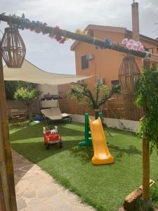 a backyard with a playground with a slide at L'Oasi Di Franco in Villa San Pietro