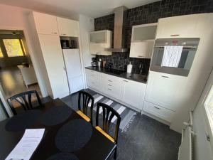a kitchen with a table with chairs and a stove at DP Apartments Vaasa IV in Vaasa