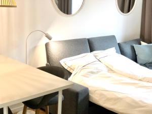a bedroom with a bed and a table with a lamp at Bayapart - apartament mieszkanie przy plaży in Gdynia
