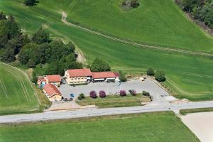 an aerial view of a building in the middle of a field at Håknäs Vandrarhem in Järna