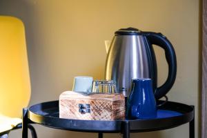 a table with a tea kettle and blue vases on it at Hammerbrook Hostel in Hamburg