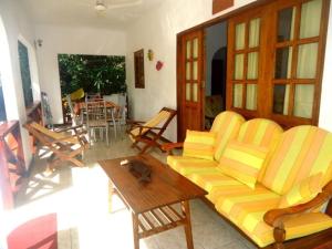 a living room with a couch and a table at Chalets Anse Possession in Baie Sainte Anne