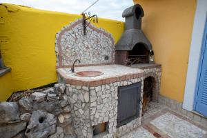 a stone fireplace with a stove in a building at Attico incantato in Rome