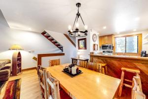 a kitchen and dining room with a wooden table at Silver Strike at Northstar in Kingswood Estates