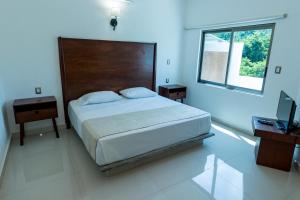 Postel nebo postele na pokoji v ubytování LA LOMA SUITES