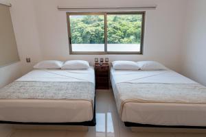 Postel nebo postele na pokoji v ubytování LA LOMA SUITES