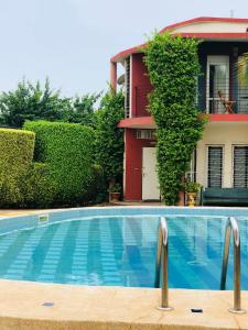 a swimming pool in front of a house at FaDu’GH in Somone