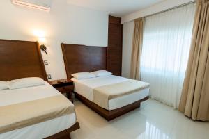 Postel nebo postele na pokoji v ubytování LA LOMA SUITES
