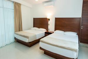 Postel nebo postele na pokoji v ubytování LA LOMA SUITES + 37 fotografií
